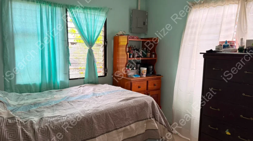 House for Sale in Lord's Bank Belize featuring a 3-bedroom concrete home and separate 1-bedroom rental home on one lot.