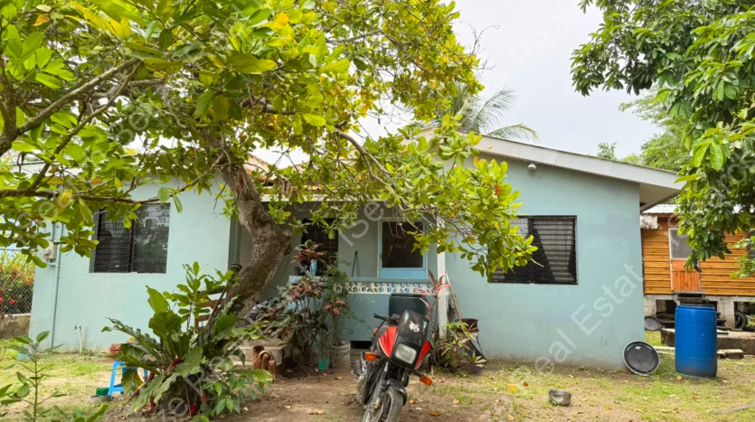 House for Sale in Lord's Bank Belize featuring a 3-bedroom concrete home and separate 1-bedroom rental home on one lot.