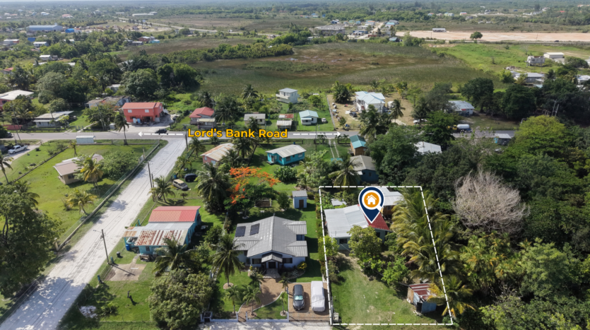 House for Sale in Lord's Bank Belize featuring a 3-bedroom concrete home and separate 1-bedroom rental home on one lot.