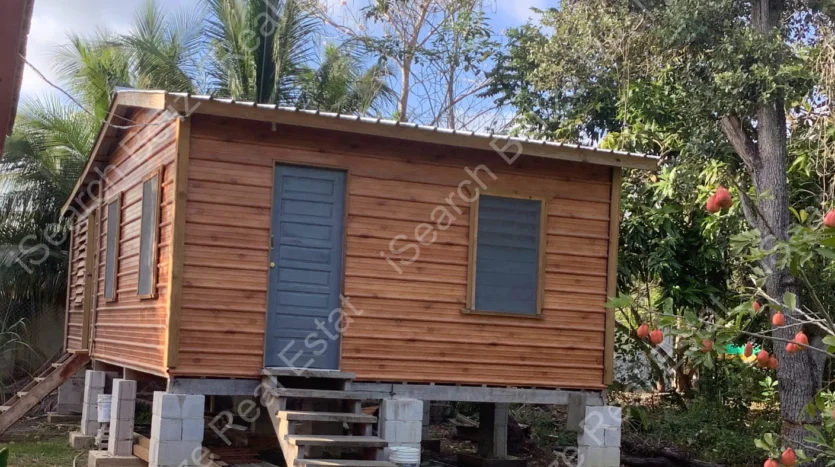 House for Sale in Lord's Bank Belize featuring a 3-bedroom concrete home and separate 1-bedroom rental home on one lot.