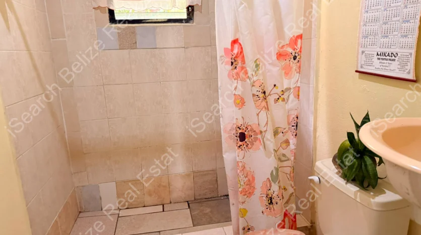 House for Sale in Lord's Bank Belize featuring a 3-bedroom concrete home and separate 1-bedroom rental home on one lot.