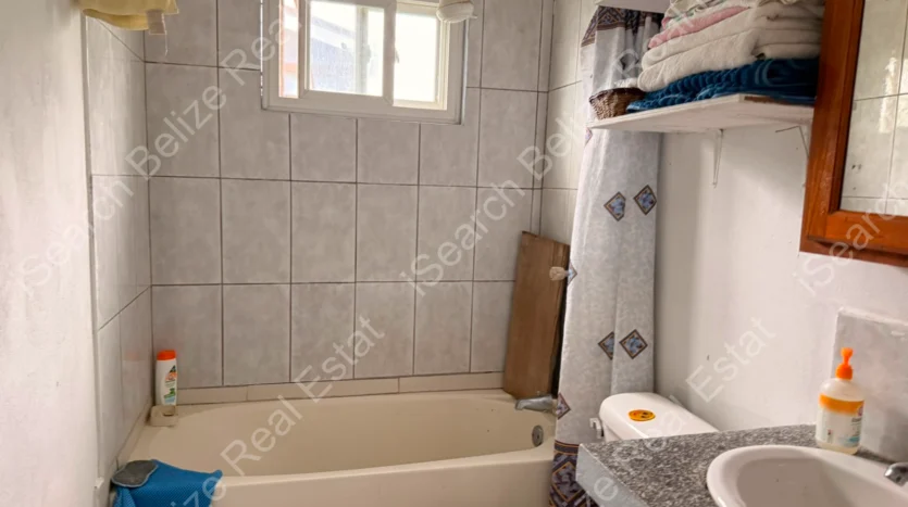 House for Sale in Lord's Bank Belize featuring a 3-bedroom concrete home and separate 1-bedroom rental home on one lot.