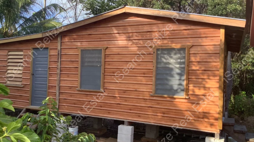 House for Sale in Lord's Bank Belize featuring a 3-bedroom concrete home and separate 1-bedroom rental home on one lot.
