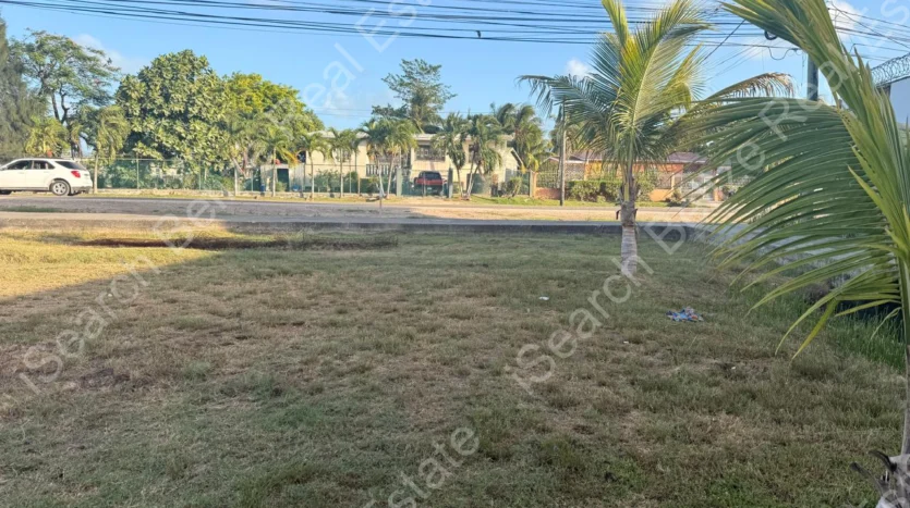 Cleared land for sale on George Price Highway Belize with 152 feet of highway frontage.